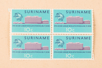 SURINAME - CIRCA 1970: A stamp printed in Suriname shows a building, circa 1970