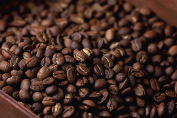 natural coffee beans in a wooden box on a natural wooden background  soft backlight