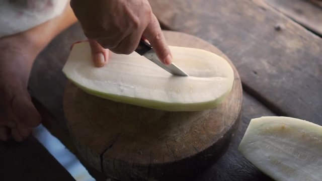 Winter melon get split in half with knife. Ingredient for cooking soup.