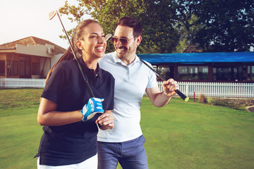 Happy couple feeling happy after golf game