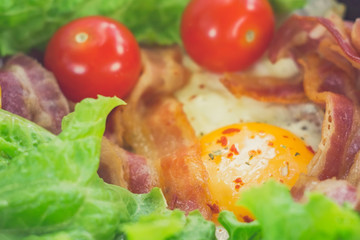 Sunny Side Up Eggs with crispy fried bacon, arugula and tomatoes