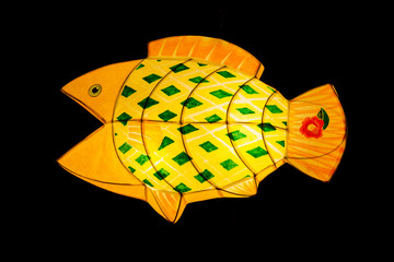 Fish lantern by paper work in dark background.