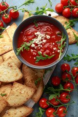 Grilled corn tortilla with sea salt flakes, spicy tomato salsa sauce and feta cheese