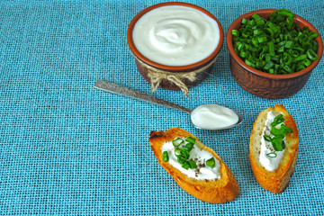 Croutons with sour cream and greens. Chopped green onions and sour cream. Sour cream. Fermented milk product. Probiotics.
