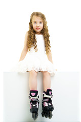 Little girl on roller skates.
