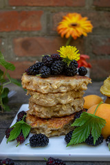 corn, oat and wheat pancakes with cherries, mulberries and apricots