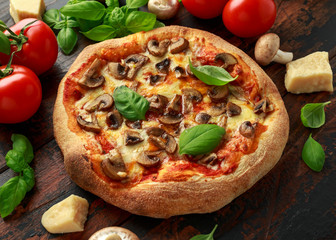 Hot Mushroom Pizza with basil, tomatoes, mozzarella and parmesan cheese on wooden table. ready to eat. vegetarian food