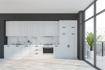 Gray and white kitchen with balcony