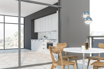 White and gray kitchen with balcony