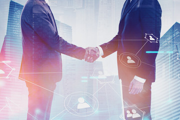 Handshake in city, social media
