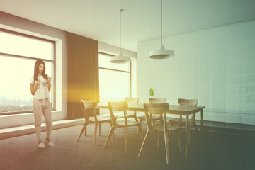 Woman in minimalistic white dining room