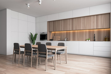White and wooden kitchen corner with table