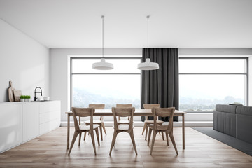 White kitchen interior, wooden table and windows