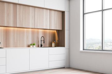 White loft kitchen corner with wood cupboards