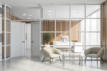 Glass office waiting room with armchairs