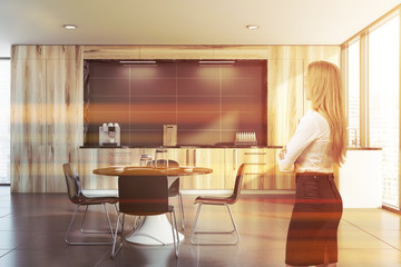 Blonde woman in wooden kitchen