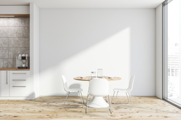 White kitchen interior with round table