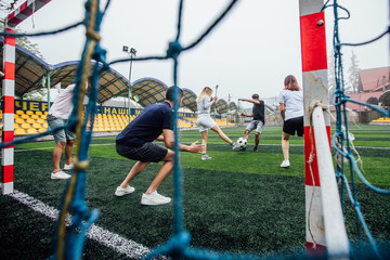 Footballers Kicking football match on the Pitch. Young teen soccer game. Youth Sport.