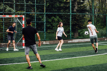 Portrait of male and female, adult  soccer teams playing together on field. Football concept..