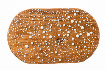 Beautiful colorful water droplets on a wooden frame. White drops of paint.