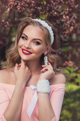 Beautiful woman with pearl jewelry and accessories Bridesmaid in peach dress