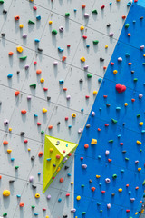 Abstract colorful of rock climbing wall with toe and hand hold studs.