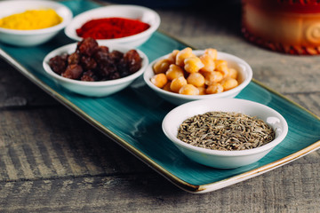 Spices in little white bowls on brown wooden background. Indian spice. Top view with space for text, copy space
