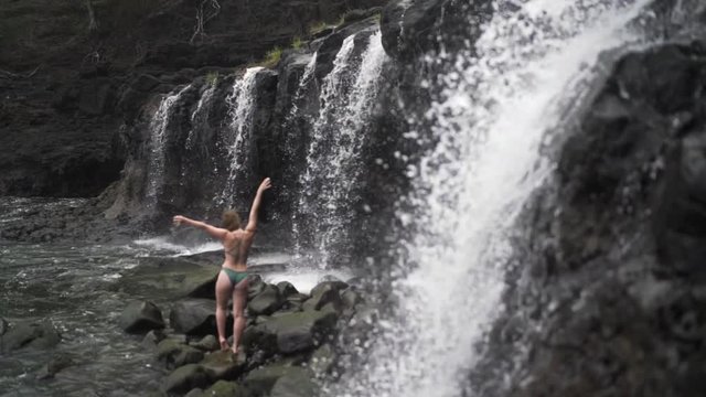 Slow Motion: Fit Young Woman in Bikini Stretches and Poses By Kauai Waterfall, Kauai, Hawaii
