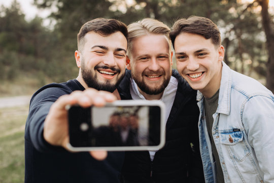 Happy friends hanging out and taking a selfie