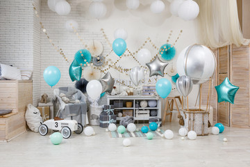 A large number of color balloons. Birthday teal and silver decorations with gifts, toys, garlands...