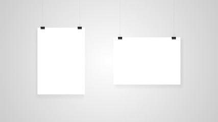 Empty advertising posters suspended from clips. Layout template on gray background.