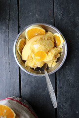 corn porridge with oranges in a plate