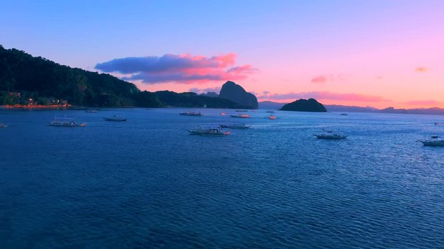 Sail boats at sunset on the sea lagoon on Corong beach in El Nido, Palawan, Philippines.