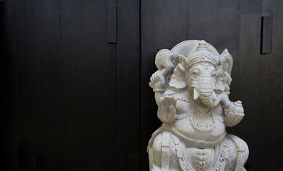 White stone sculpture on a blank black background