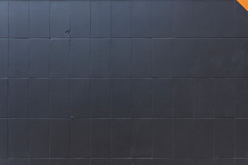Black paint over a tiles grid, orange corner