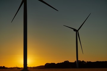 Fototapeta na wymiar Two wind turbines at sunset