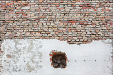 Old grunge brick wall and hole with ventilator propellers