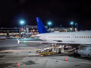 Airport runway with some airplanes, night shot with large copyspace