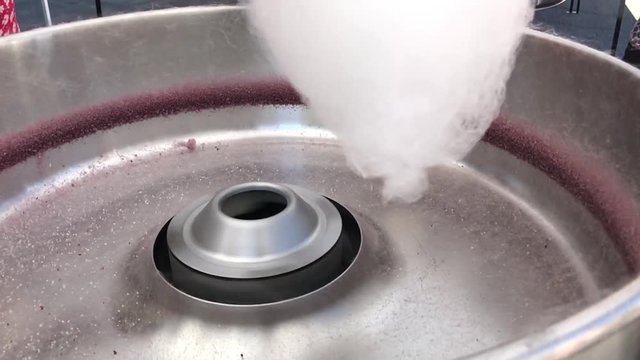 Pouring sugar into cotton candy machine slow motion
