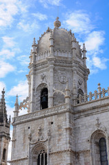 Fototapeta na wymiar Dome and tower of the Church of Santa Maria in the Jerónimos Monastery. Lisbon, Portugal