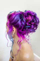 Portrait of a young beautiful woman with colored hair. Bright shades of blue and purple, gradient hair.