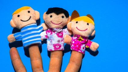 Puppet theater. Hand wearing finger family members puppets: mom, father, daughter, son. single mother concept.