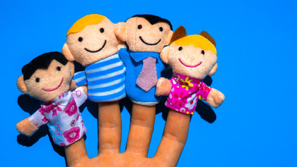 Puppet theater. Hand wearing finger family members puppets: mum, dad, father, mom, daughter, son....