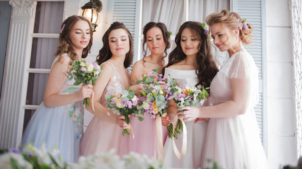 Happy girls at their best friend's wedding. Beautiful and elegant bride with her friends.