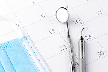 Reminder dentist appointment in calendar and professional dental tools.