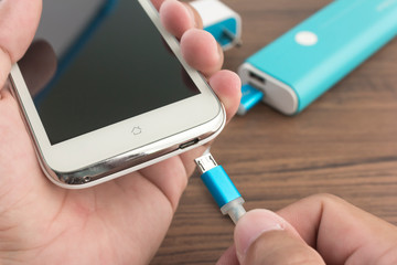 top view of powerbank charging smartphone with copy space