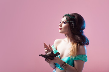 Prince Jasmine, a young woman in the image of an Eastern fairy Princess. The girl calls gin and makes a wish.