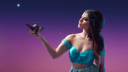 Oriental fairy tale, a young Princess woman with a magic lamp in her hands.