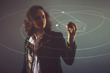 Physics the science of nature, the concept of studying the laws of nature. A young man in the image of Isaac Newton.