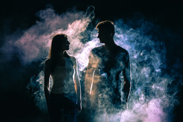 The silhouette of couple in the smoke